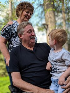 Grandparents and grandchild smiling at one another