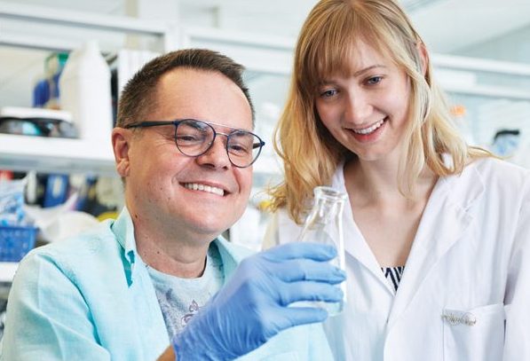 ALS researcher in the lab with a person living with ALS