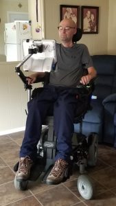 Man sitting in power wheelchair using eye gaze technology